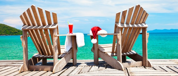 a pair of chairs on a dock overlooking the water