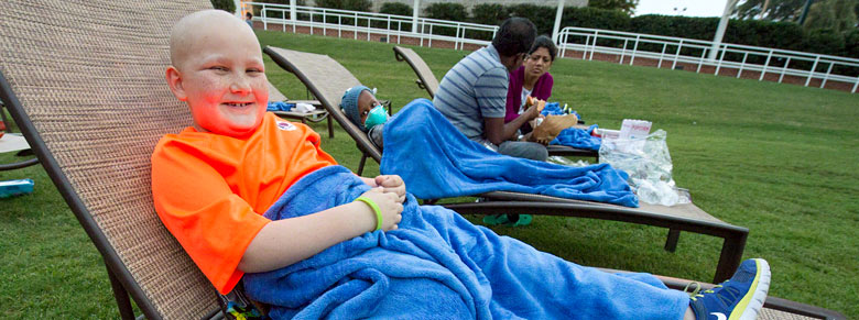 kids sitting in lounge chairs for st jude event