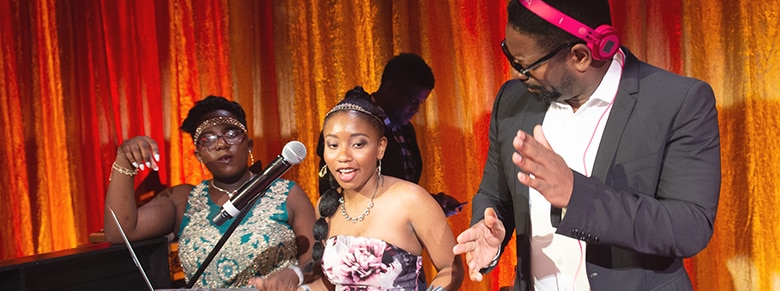 a girl, woman and a man dancing while they spin music