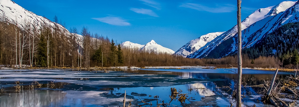 view of the lake and mountains covered in snow