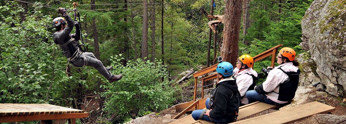 zipline through the trees in klondike adventure park