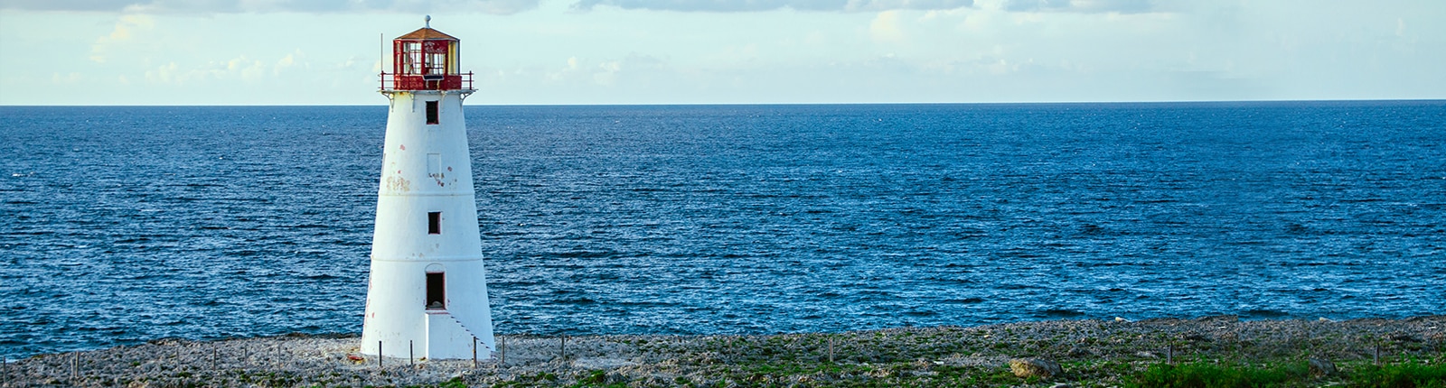 A lighthouse with Freeport beach in the background