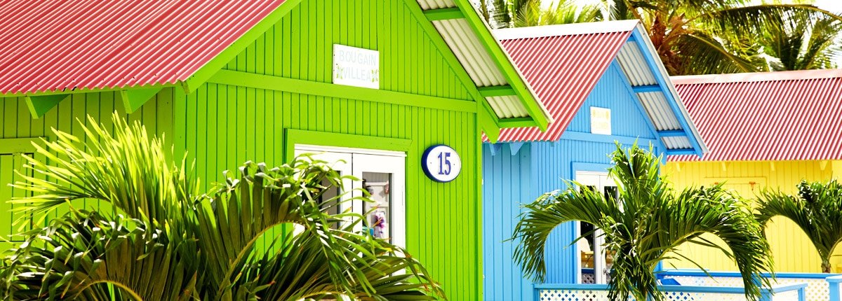 pastel colored private beach bungalows in princess cays