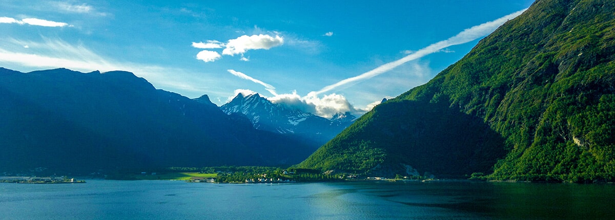 great green mountains and serene lake on the fjord in andalsnes, norway