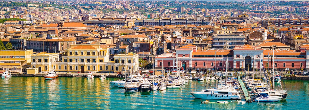 boats lining the coast in catania, sicily