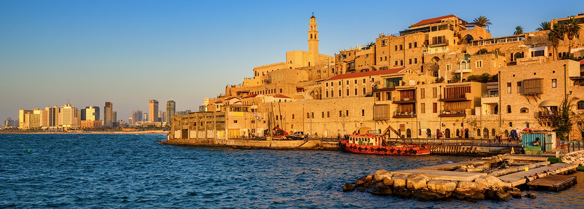 multistory buildings are located near the shoreline of haifa