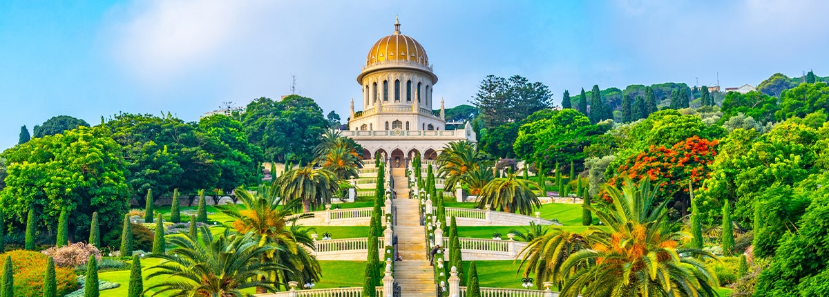 the bahai garden is decorated with lush trees and vibrant flowers