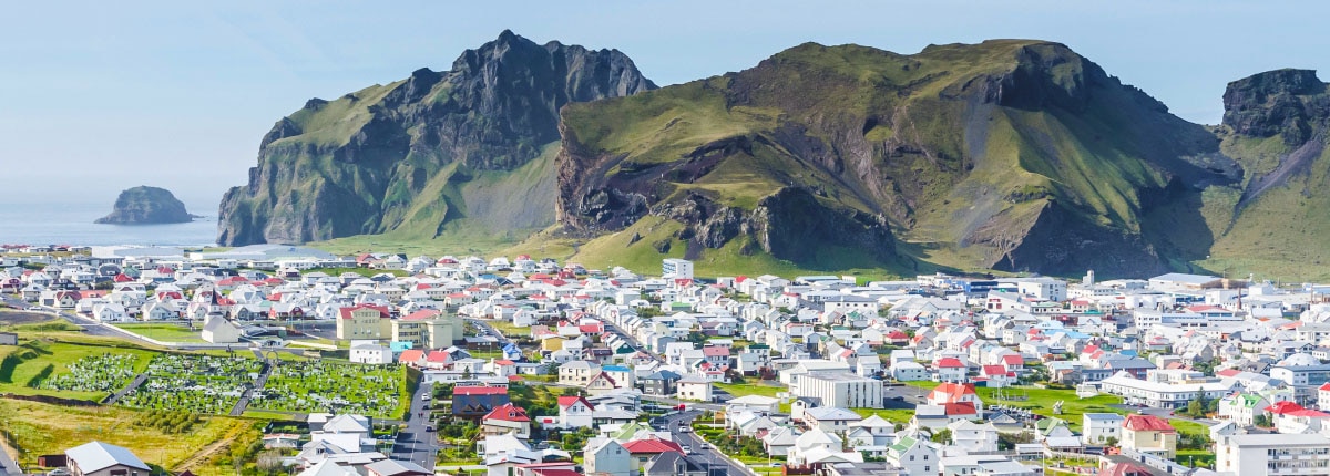 numerous homes surrounded by mountains