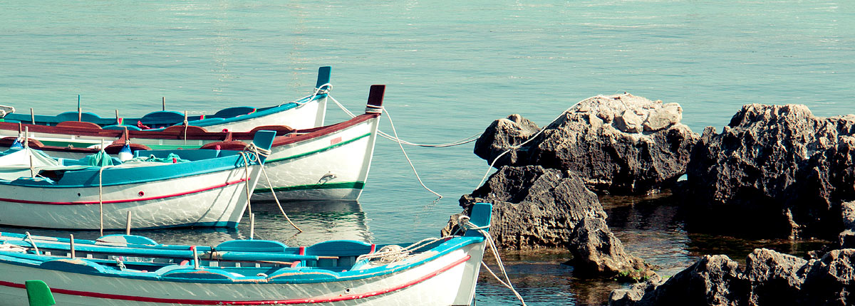 boats tied down in the mediterranean sea on the coast of palermo