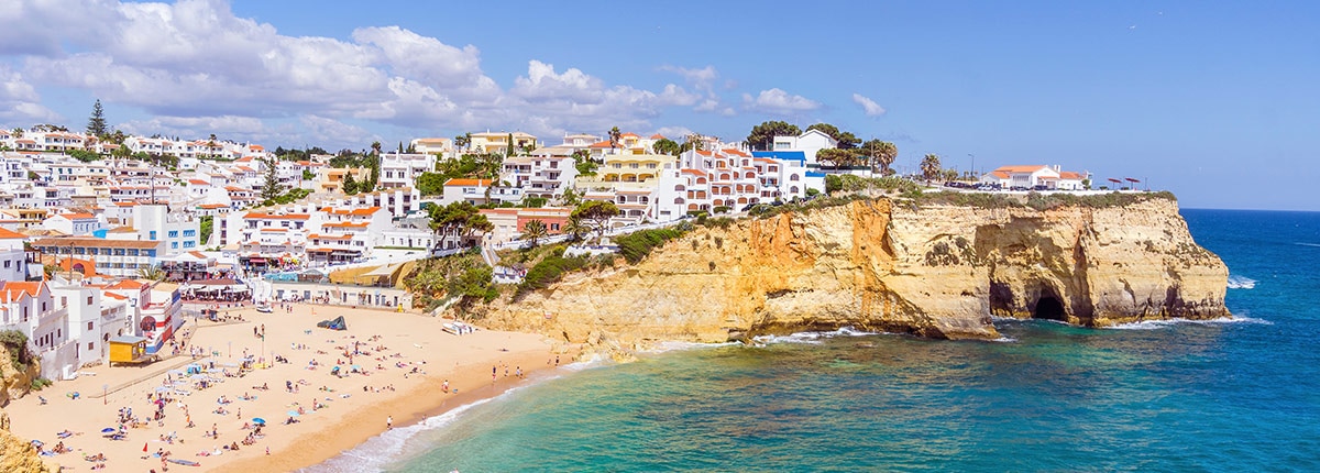 beautiful carvoeiro with colorful houses by beautiful, sandy beach