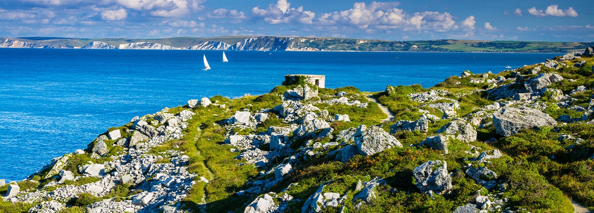 two sail boats sail off the coast of dorset