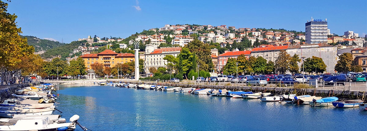 view of the city of rijeka with the mountains in the background