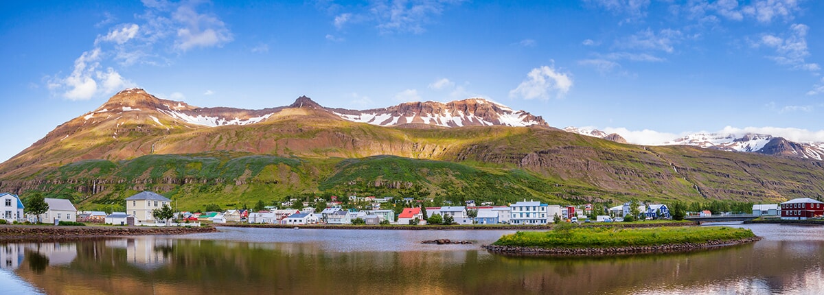 panoramic view of seydisfjordur, iceland with mountains in the background