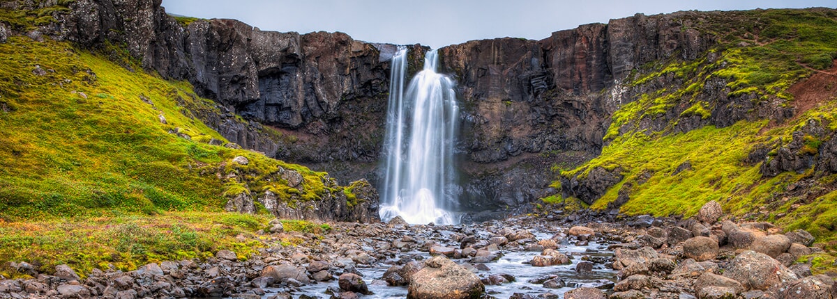 the gufufoss waterfall in seydisfjordur, iceland