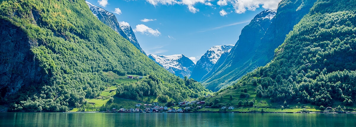 view of the town and green mountains from sognefjord