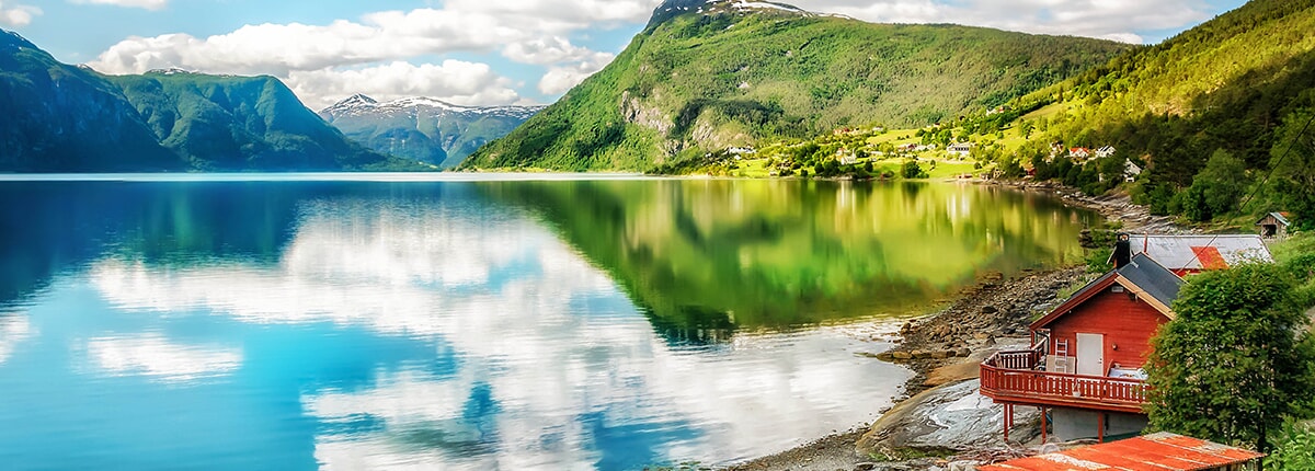 view of red house and green mountains on lustrafjorden 