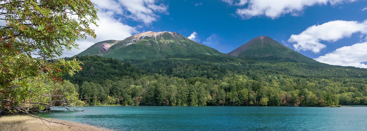 beautiful mountains surrounded by a lake in kushiro, japan