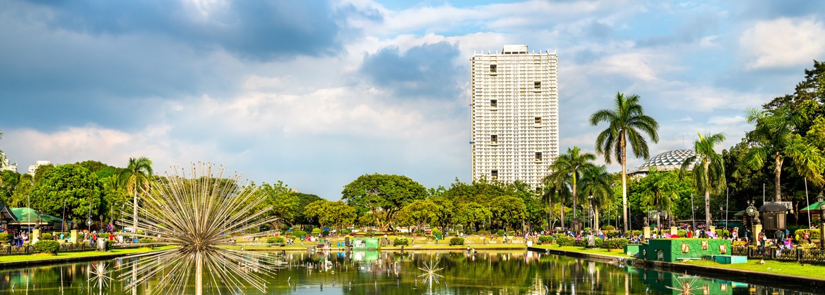 lovely view of a fountain at the rizal park on a sunny day in manila, philippines 