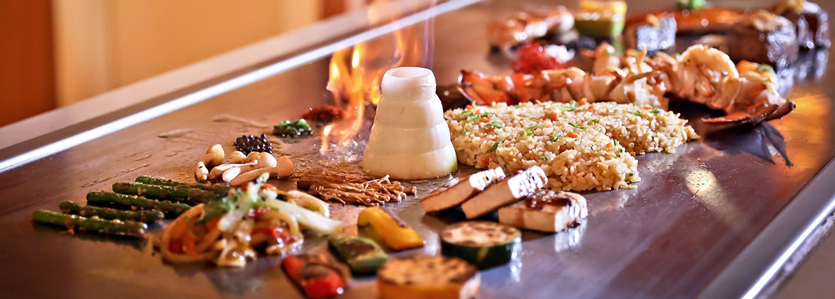 food is being cooked on a fire grill