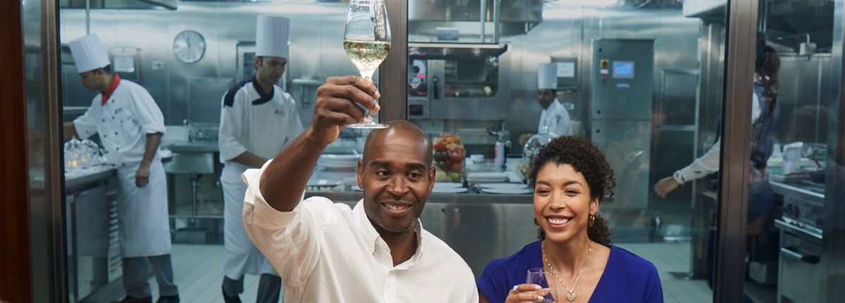 guests enjoying a cup of wine at the chef's table