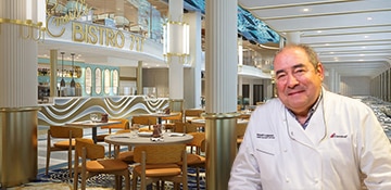 emeril stands infront of emerils bistro 717