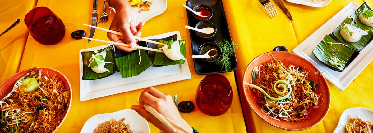 Table with noodles and pot stickers at JI JI Asian Kitchen