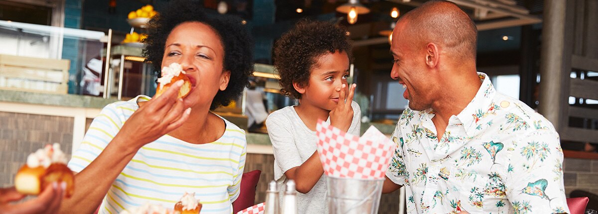 a family of three enjoys a meal at seafood shack