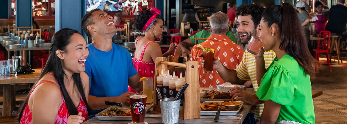 four guests laugh it up while enjoying a meal at guys pig and anchor smokehouse brewhouse