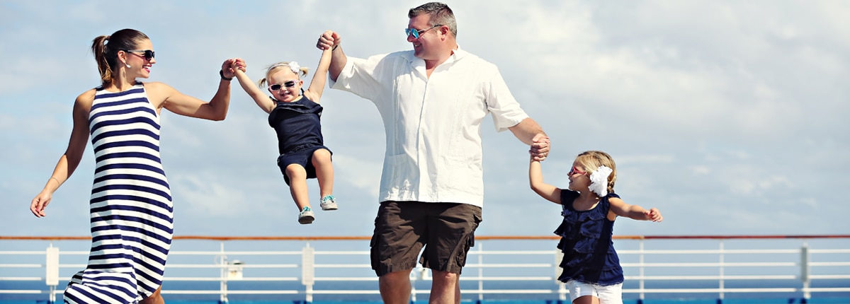 a family of four spends some playful time together on deck