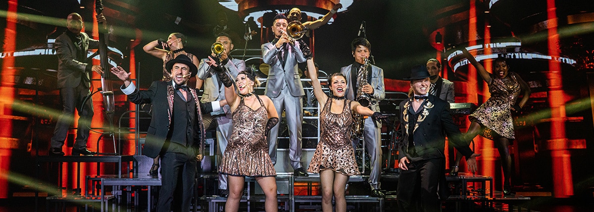 a group of actors dancing and playing instruments in vintage pop