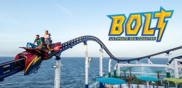 man and woman ride bolt roller coaster above ship deck and with the ocean as their backdrop