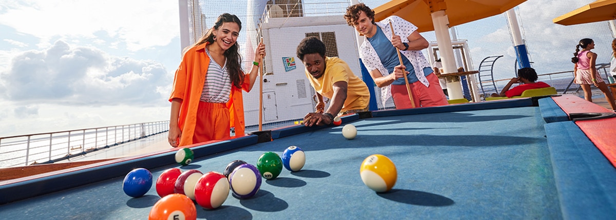 three friends play a game of pool