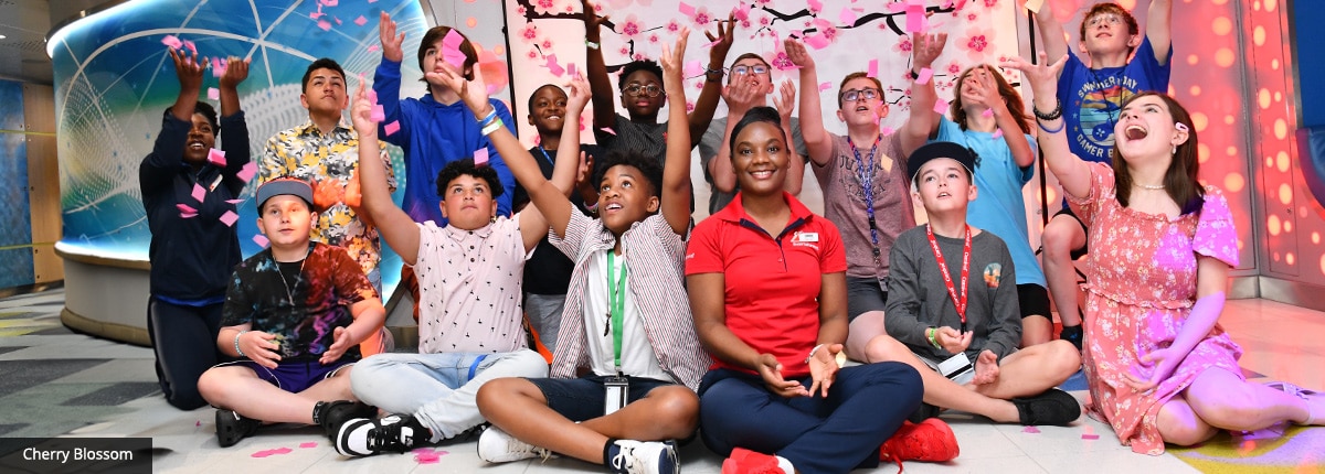 group of kids and adults throwing petals in the air