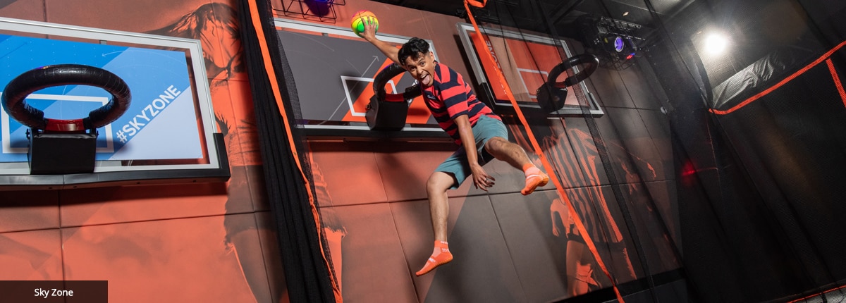 boy playing basketball at sky zone on carnival panorama