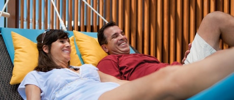 a couple resting on a hammock